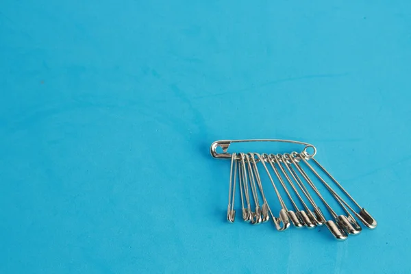 Top View Bunch Safety Pins Blue Background — Stock Photo, Image
