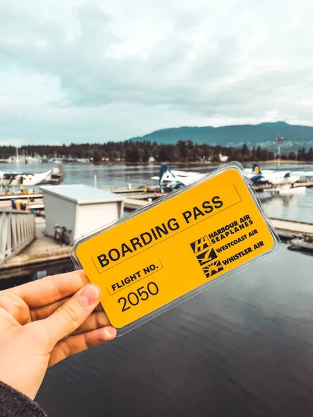 A scenic shot of a sea-plane ticket in front of a beautiful ocean view.