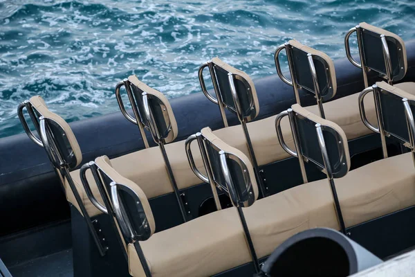A closeup shot of Rows of seats on a boat