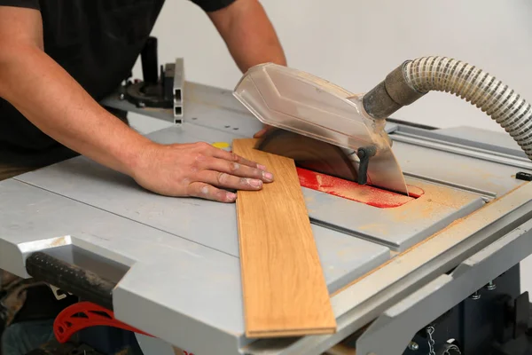 Der Arbeiter Schneidet Das Parkett Manuell Mit Der Kreissäge — Stockfoto