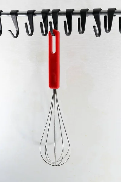 Vertical Shot Whisk Red Handle Hanging White Wall — Stock Photo, Image