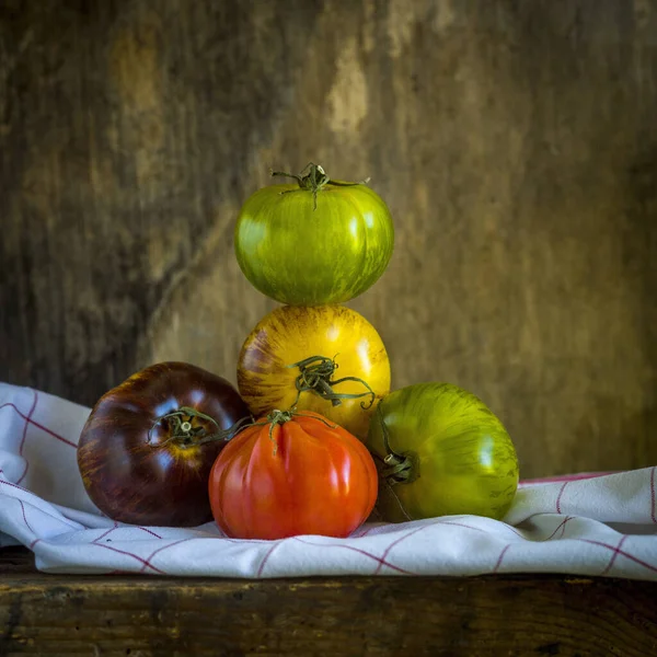Eine Nahaufnahme Von Einem Haufen Erbstücke Tomaten Auf Einer Stoffoberfläche — Stockfoto