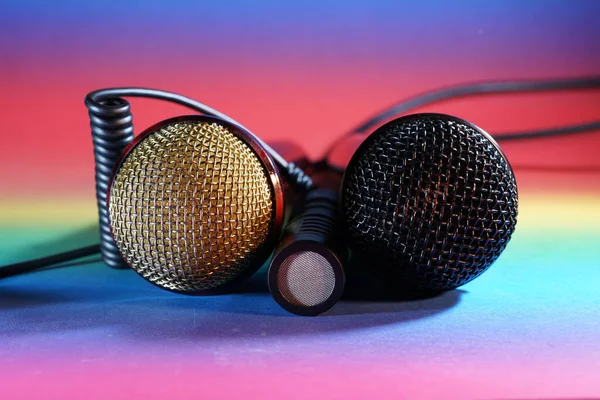 stock image A closeup shot of headphone and microphones on a colorful background