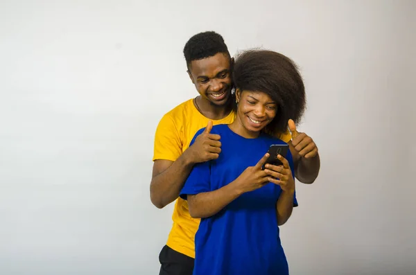 Cute Young African Couple Looking Phone Giving Thumbs Smiling — Stock Photo, Image