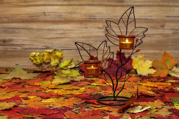 Closeup Shot Candle Stand Flames Dried Maple Leaves — Stock Photo, Image