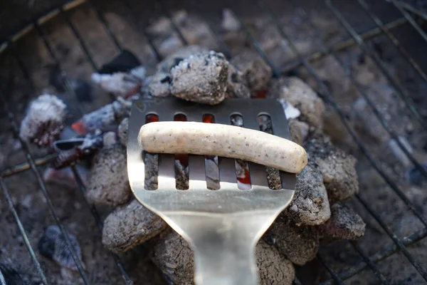 Closeup Shot Sausage Metal Spatula Flaming Charcoal — Stock Photo, Image