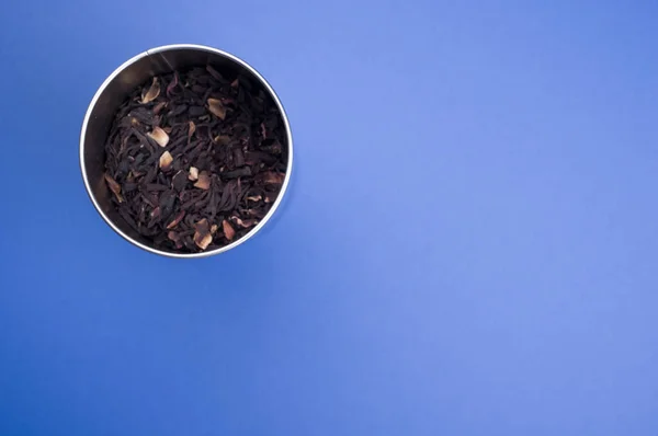 Closeup Shot Dried Hibiscus Tea Leaves Metal Container Blue Surface — Stock Photo, Image