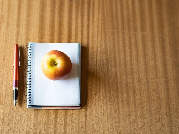 Top View Apple Notebook Pen Wooden Table Royalty Free Stock Photos