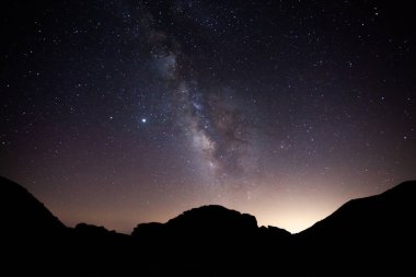A perfect milky way over a silhouette of mountains in Sierra Nevada, Spain clipart