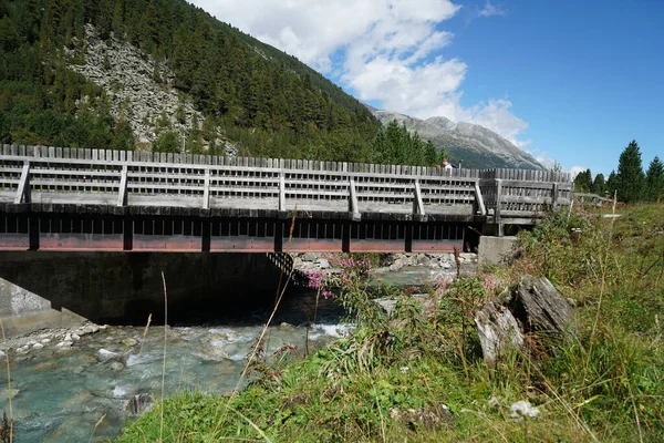 Zbliżenie Małego Mostu Nad Rzeką Zielonymi Polami Górami Tle — Zdjęcie stockowe