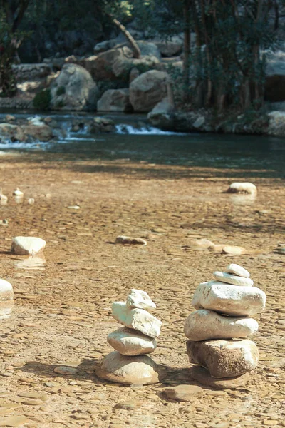 A vertical shot of rocks put on each other near a river — Stock Image Vertical Shot Rocks Put Each Other River Royalty Free Stock Photos