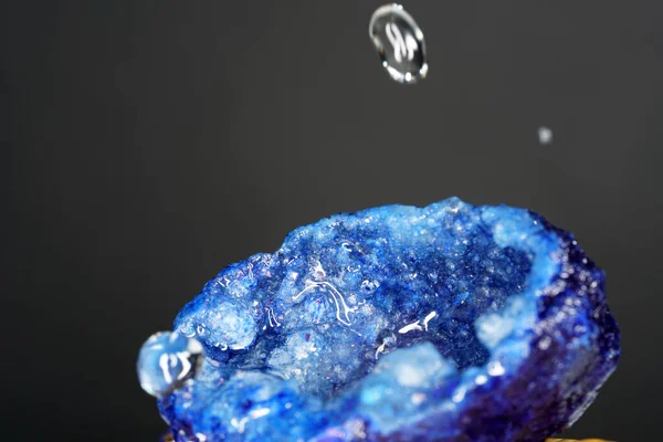 A beautiful shot of blue Agate stone with water drops