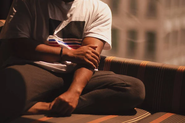 African Male Sitting Next Window Holding His Arm His Hand — Stock Photo, Image