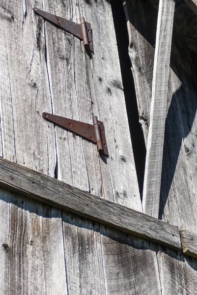 一把带有生锈铰链的旧木门的垂直截图 — 图库照片