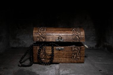 Dark image of a trunk with pirates treasures clipart