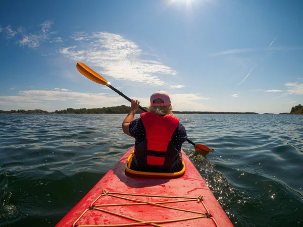 A closeup shot of female kayaking in the sea at daytime