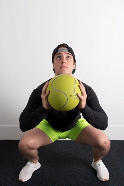 Plan Vertical Jeune Homme Faisant Des Squats Avec Une Balle — Photo