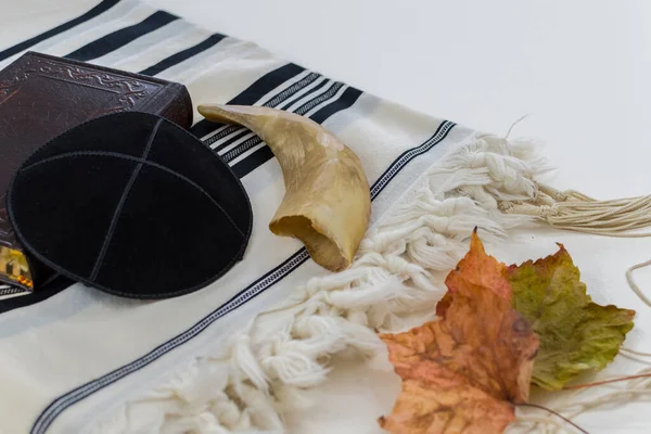 Orthodox Jewish man with tefillin and tallit, sitting alone and