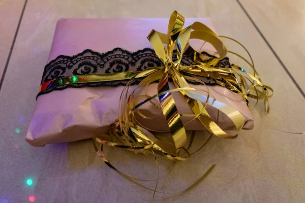 Closeup Shot Present Wrapped Pink Paper Black Lace Golden Ribbon — Stock Photo, Image