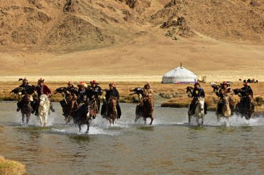 ULGII, MONGOLIA - Sep 30, 2019: The Eagle hunters of Mongolia in the Golden Altai mountains area. Portrait and sport photography clipart