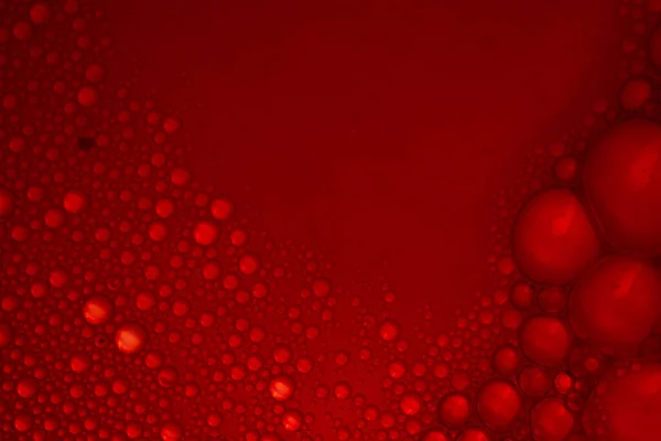 赤い背景に泡のマクロショット 壁紙や背景に最適です — ストック写真