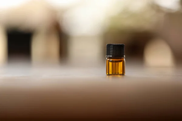 Closeup Small Bottle Amber Essential Oil Table Blurry Background — Stock Photo, Image