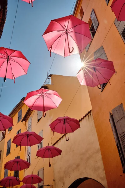 Вертикальный Снимок Розовых Зонтиков Висящих Над Улицей Грассе Франция — стоковое фото