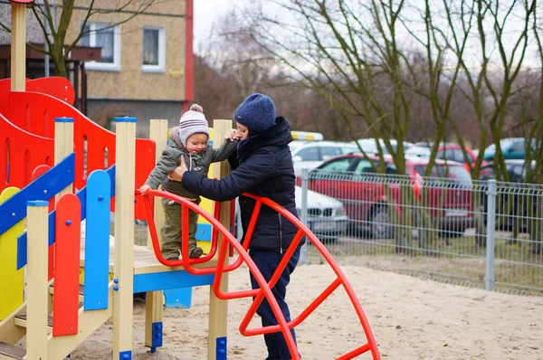 Poznan Poland Jan 2015 Woman Helping Toddler Equipment Playground Cold — Stock Photo, Image
