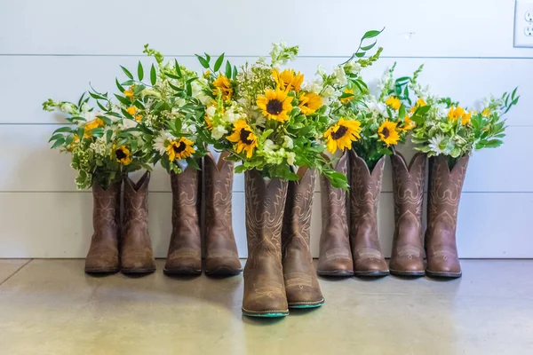 A closeup shot of sunflowers in boots