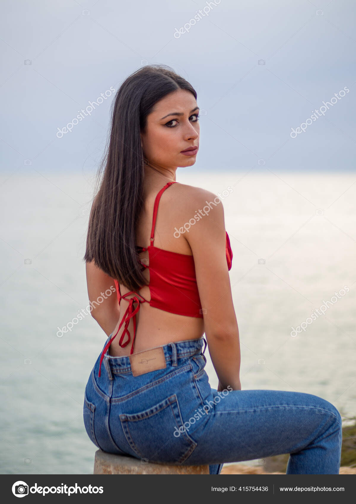 Beautiful Young Female Wearing Sexy Red Open Back Crop Top Stock