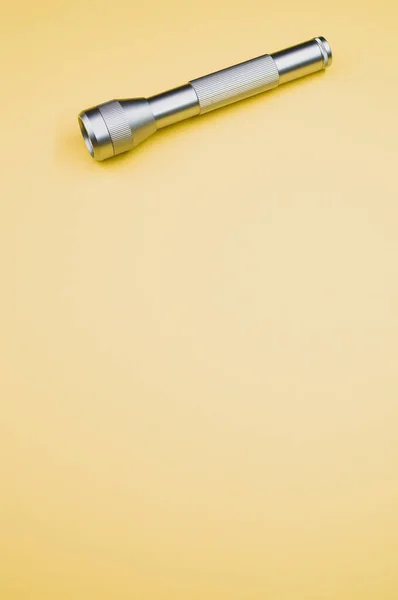 Silver Flashlight Light Yellow Background — Stock Photo, Image