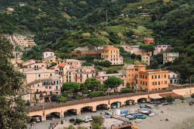 A cityscape of Monterosso al Mare with picturesque green hills on the background, Five lands, Italy clipart