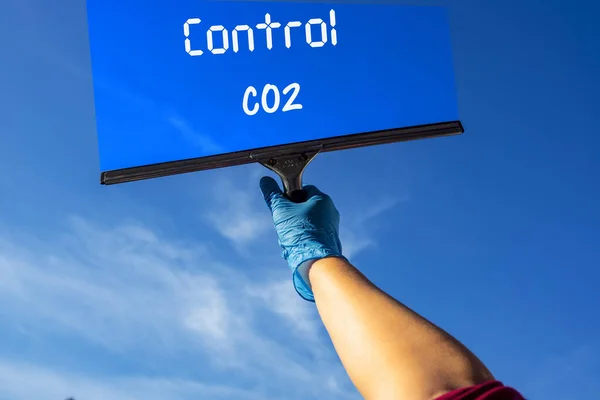 コントロール二酸化炭素テキストが付いた窓を清掃するためのゴムスクレーパーを有する者 — ストック写真