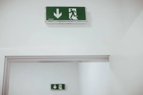 Emergency exit sign on a white wall