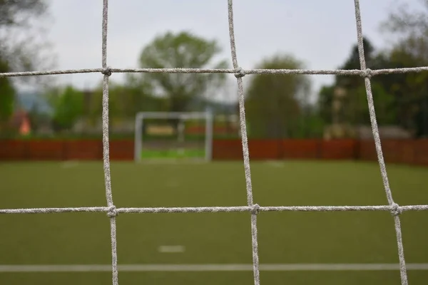Closeup Football Goal Net Field Covered Greenery Blurry Background — Stock Photo, Image