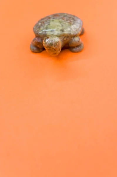 Vertical Shot Brown Turtle Stone Figurine Isolated Orange Background — Stock Photo, Image