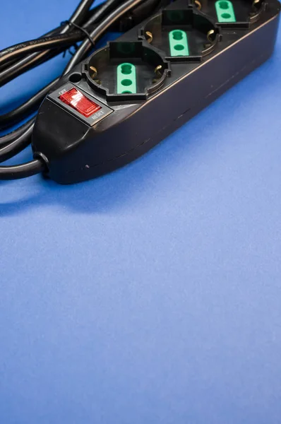 青い表面に電気延長コードのクローズアップショット — ストック写真