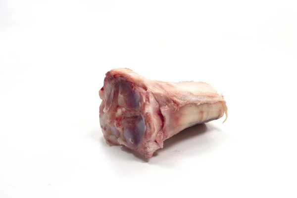 A closeup shot of veal shank bone isolated on a white background
