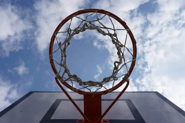 Bulutlu Bir Gökyüzüne Karşı Bir Basketbol Yüzüğünün Düşük Açılı Çekimi — Stok fotoğraf