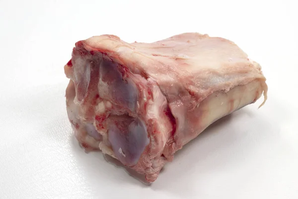 A closeup shot of veal shank bone isolated on a white background