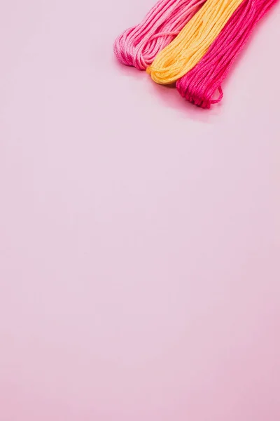 Colpo Verticale Filati Colorati Isolati Uno Sfondo Rosa — Foto Stock