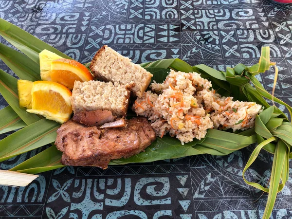 Typical Polynesian food in Bora Bora. Banana dish with fruits and fish