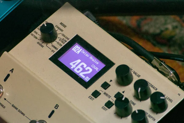 A selective focus shot of professional pedalboard, electric guitar pedal set