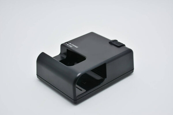 Black digital single lens reflex (DSLR) battery charger