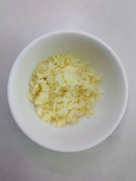 Crushed garlic put at small bowl serve in shabu shabu hotpot restaurant