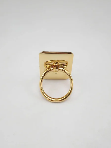 Smart phone ring stand gold color use to insert fingers while holding the phone