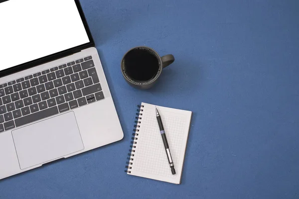 Top view workspace mockup, blank screen laptop, coffee mug, note