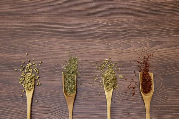 Mix spice, Red pepper, mint and thyme in wooden spoon
