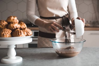 Mutfak masasında çikolata hamuru yapan kadın. Evde yemek pişirmek. Ev yapımı pasta.. 
