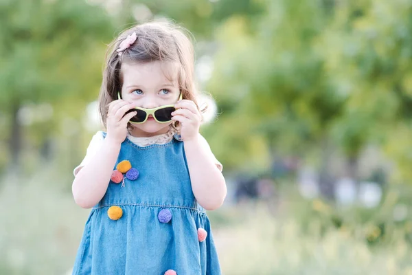 Pretty Child Girl Year Old Holding Sun Glasses Denim Dress — Stock Photo, Image